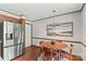Bright dining area boasts modern lighting, stainless steel refrigerator, and natural light at 2281 Old Salisbury Concord Rd, Concord, NC 28025