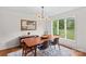 Bright dining room boasts natural light, hardwood floors, and views of the lush backyard at 2281 Old Salisbury Concord Rd, Concord, NC 28025