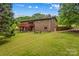 Brick home with outdoor deck, fire pit, and sprawling lawn, perfect for outdoor enjoyment at 2281 Old Salisbury Concord Rd, Concord, NC 28025