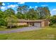 Spacious single-story home featuring stone and brick, an attached garage, and a well-maintained lawn at 2281 Old Salisbury Concord Rd, Concord, NC 28025