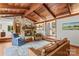 Inviting living room with a stone fireplace, wood-beamed ceiling, hardwood floors, and cozy furniture at 2281 Old Salisbury Concord Rd, Concord, NC 28025