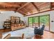 Cozy living room with a wood-beamed ceiling, a bookshelf, and access to an outdoor deck at 2281 Old Salisbury Concord Rd, Concord, NC 28025