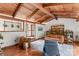 Comfortable living room with a wood-beamed ceiling, bookshelf, and a view of the entry at 2281 Old Salisbury Concord Rd, Concord, NC 28025
