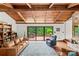 Inviting living room features wood-beamed ceilings, leather sofa, and sliding glass doors to the deck at 2281 Old Salisbury Concord Rd, Concord, NC 28025