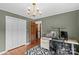 Well-lit home office features wood floors, a modern chandelier, and an adjacent closet at 2281 Old Salisbury Concord Rd, Concord, NC 28025