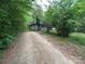 View of a home from a long driveway surrounded by lush greenery at 267 Hall Nw Ave, Concord, NC 28027