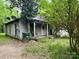 Exterior view of a home with a covered porch and mature trees at 267 Hall Nw Ave, Concord, NC 28027