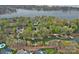 An aerial view of lakefront homes with mature trees and boat docks at 276 Greyfriars Rd, Mooresville, NC 28117