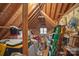 Unfinished attic area showing the beams, insulation, storage containers and natural light at 276 Greyfriars Rd, Mooresville, NC 28117