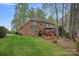 Expansive backyard featuring a large brick home with a spacious wooden deck perfect for outdoor gatherings at 276 Greyfriars Rd, Mooresville, NC 28117