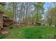 Expansive backyard featuring a deck, lake access, and lush greenery, creating a private outdoor oasis at 276 Greyfriars Rd, Mooresville, NC 28117