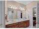 Well-lit bathroom features a double sink vanity, a large mirror, and classic fixtures at 276 Greyfriars Rd, Mooresville, NC 28117