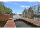 Private dock with a boat slip offers direct water access and scenic views for an idyllic lakeside lifestyle at 276 Greyfriars Rd, Mooresville, NC 28117