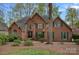 Charming red brick home with green shutters, mature landscaping, and a welcoming front entrance at 276 Greyfriars Rd, Mooresville, NC 28117