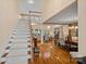 Inviting foyer with hardwood floors, staircase, and an open view to the living and dining areas at 276 Greyfriars Rd, Mooresville, NC 28117