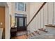 Elegant foyer with hardwood floors, staircase, dark wood door, and a large window for natural light at 276 Greyfriars Rd, Mooresville, NC 28117