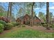 Charming brick home with manicured lawn and lush landscaping, showcasing its inviting curb appeal at 276 Greyfriars Rd, Mooresville, NC 28117