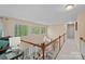 Hallway with carpet, wood railing, lots of sunlight and views through large windows at 276 Greyfriars Rd, Mooresville, NC 28117