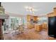 Open kitchen and dining area with natural light, featuring wooden cabinets and tile floors at 276 Greyfriars Rd, Mooresville, NC 28117