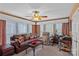 Comfortable living room featuring a large window, a leather sofa, and a ceiling fan at 276 Greyfriars Rd, Mooresville, NC 28117