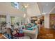 Cozy living room featuring a fireplace, hardwood floors, and access to an outdoor area through French doors at 276 Greyfriars Rd, Mooresville, NC 28117