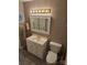 Cozy bathroom features a white vanity, framed mirror, and a standard toilet for essential functionality at 3025 School St, Claremont, NC 28610