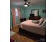 Bright bedroom with light blue walls and light pink curtains and bedding at 3025 School St, Claremont, NC 28610