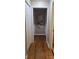 Neutral hallway features hardwood flooring and a beach themed print at the end of the hall at 3025 School St, Claremont, NC 28610
