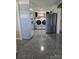 Convenient laundry room area with side-by-side washer, dryer, and ample storage at 3025 School St, Claremont, NC 28610