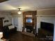 Inviting living room with a brick fireplace, ceiling fan, and comfortable seating area at 3025 School St, Claremont, NC 28610