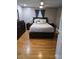Well-lit main bedroom with hardwood floors, ceiling fan, and dark wood furniture at 3025 School St, Claremont, NC 28610