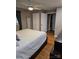 Spacious main bedroom with hardwood floors, ceiling fan, and walk in closet at 3025 School St, Claremont, NC 28610