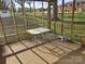 Enclosed sunroom with table, stool, and views of the backyard at 3025 School St, Claremont, NC 28610