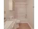 Clean bathroom with marble countertop sink, white cabinet and a bathtub with shower at 3227 Deshler Morris Ln, Charlotte, NC 28216