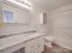 Well-lit bathroom featuring a granite countertop vanity, decorative mirror, and a shower-tub combo at 3227 Deshler Morris Ln, Charlotte, NC 28216