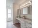 Bathroom vanity with sink and drawers plus an adjacent shower and tub at 3227 Deshler Morris Ln, Charlotte, NC 28216