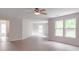 Large bedroom with hardwood floors, a ceiling fan and multiple windows for natural light at 3227 Deshler Morris Ln, Charlotte, NC 28216