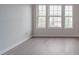 Bright bedroom with light gray flooring and natural light coming through three large windows at 3227 Deshler Morris Ln, Charlotte, NC 28216