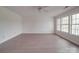 Bright bedroom with three large windows, hardwood floors, and a ceiling fan at 3227 Deshler Morris Ln, Charlotte, NC 28216