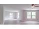Spacious bedroom with hardwood floors, three large windows, and a ceiling fan at 3227 Deshler Morris Ln, Charlotte, NC 28216