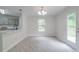 Bright dining area with door, window, and kitchen access at 3227 Deshler Morris Ln, Charlotte, NC 28216