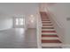 Open-concept entryway featuring wood stairs, light gray flooring, and lots of natural light at 3227 Deshler Morris Ln, Charlotte, NC 28216