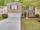 Traditional brick home featuring an attached two-car garage and a well-maintained front lawn at 3227 Deshler Morris Ln, Charlotte, NC 28216