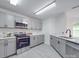 Grey cabinets, stainless appliances, and marble counters enhance this modern kitchen at 3227 Deshler Morris Ln, Charlotte, NC 28216