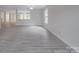 Expansive living area with gray floors and white walls; a canvas for your style and a haven for relaxation at 3227 Deshler Morris Ln, Charlotte, NC 28216
