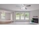 Bright living room with fireplace, ceiling fan, and ample natural light at 3227 Deshler Morris Ln, Charlotte, NC 28216