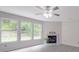 Bright living room with fireplace, light flooring, and large windows offering serene outdoor views and natural light at 3227 Deshler Morris Ln, Charlotte, NC 28216