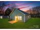 Exterior view of backyard featuring lawn, patio, and twilight sky above the home at 327 Lincoln Sw St, Concord, NC 28025