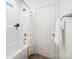 Clean bathroom featuring a shower-tub combo, modern fixtures, and neutral tones at 327 Lincoln Sw St, Concord, NC 28025