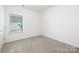 This bedroom offers bright, neutral carpeting and a window for natural light at 327 Lincoln Sw St, Concord, NC 28025